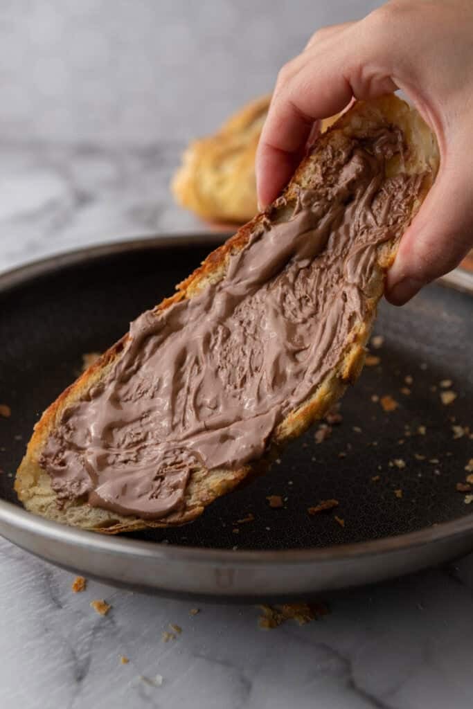 a slice of the Croissant Sourdough Bread Recipe being toasted