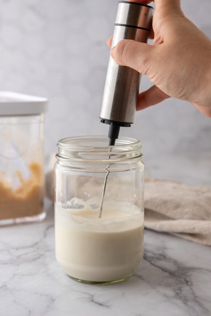 dairy ingredients in a glass jar getting whipped