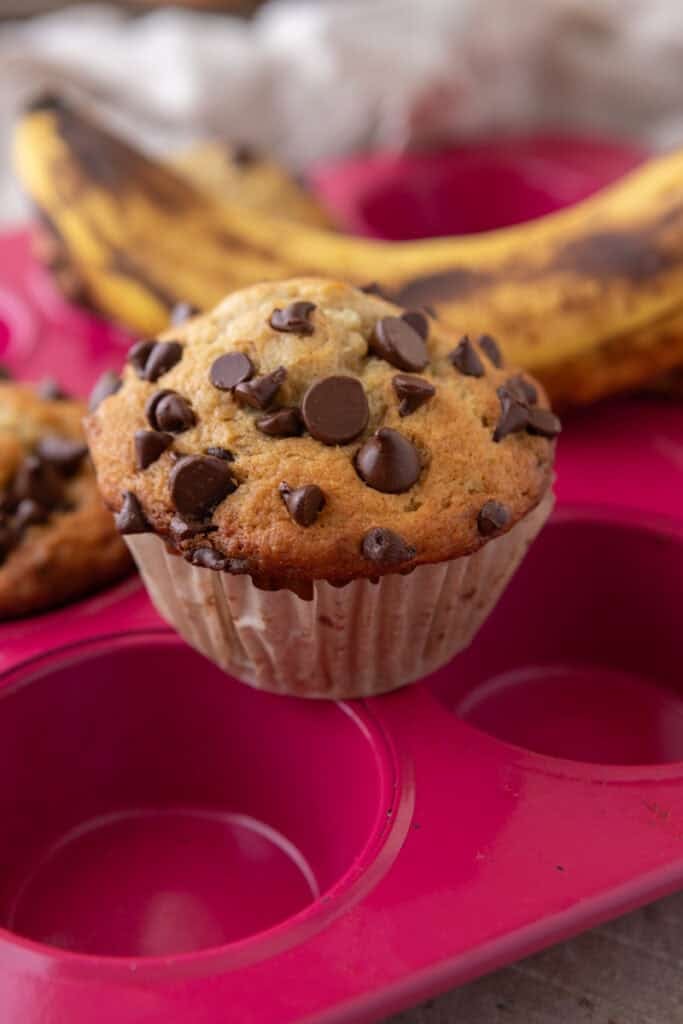 Banana chocolate chip muffins on a baking sheet