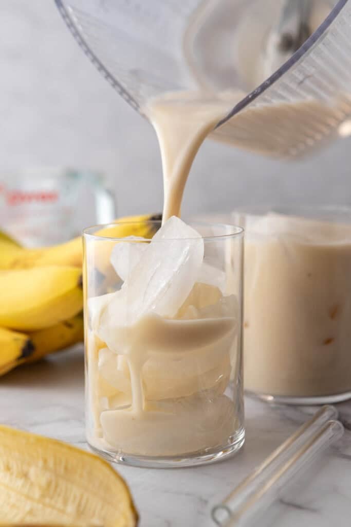 Korean Banana Milk Recipe being poured into a glass