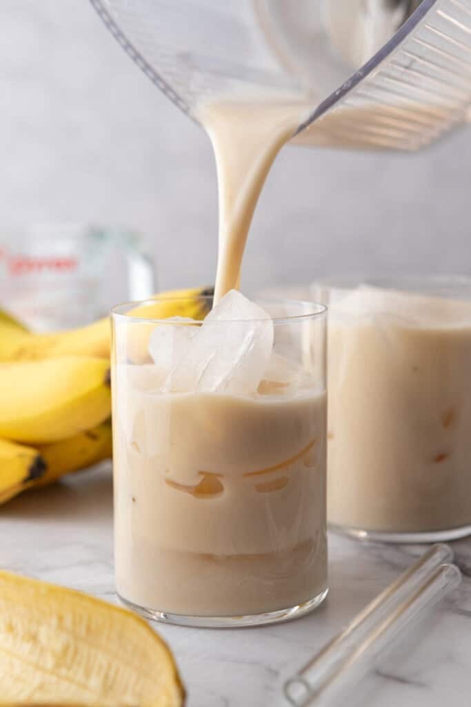 Korean Banana Milk Recipe being poured into a glass