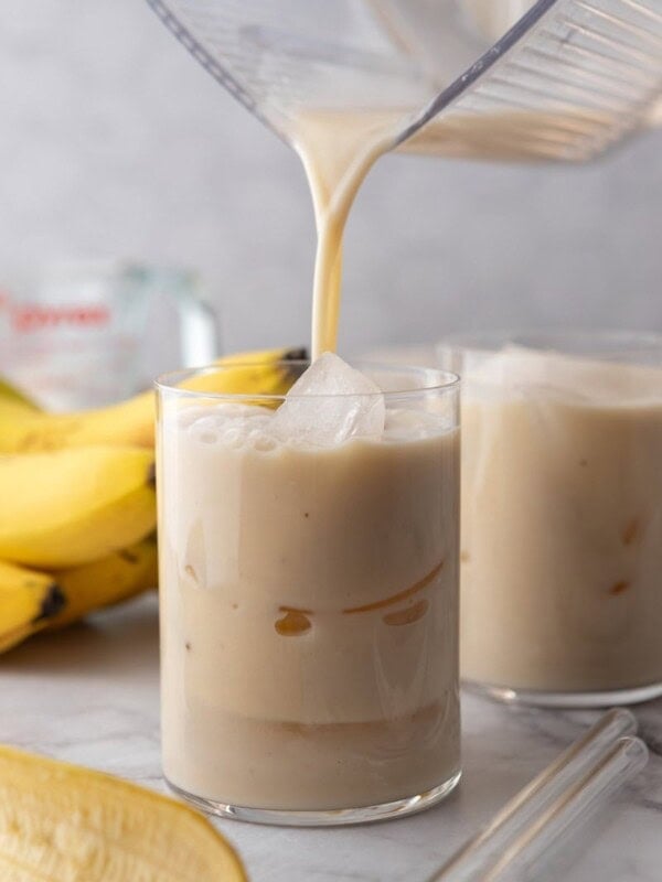 Korean Banana Milk Recipe being poured into a glass