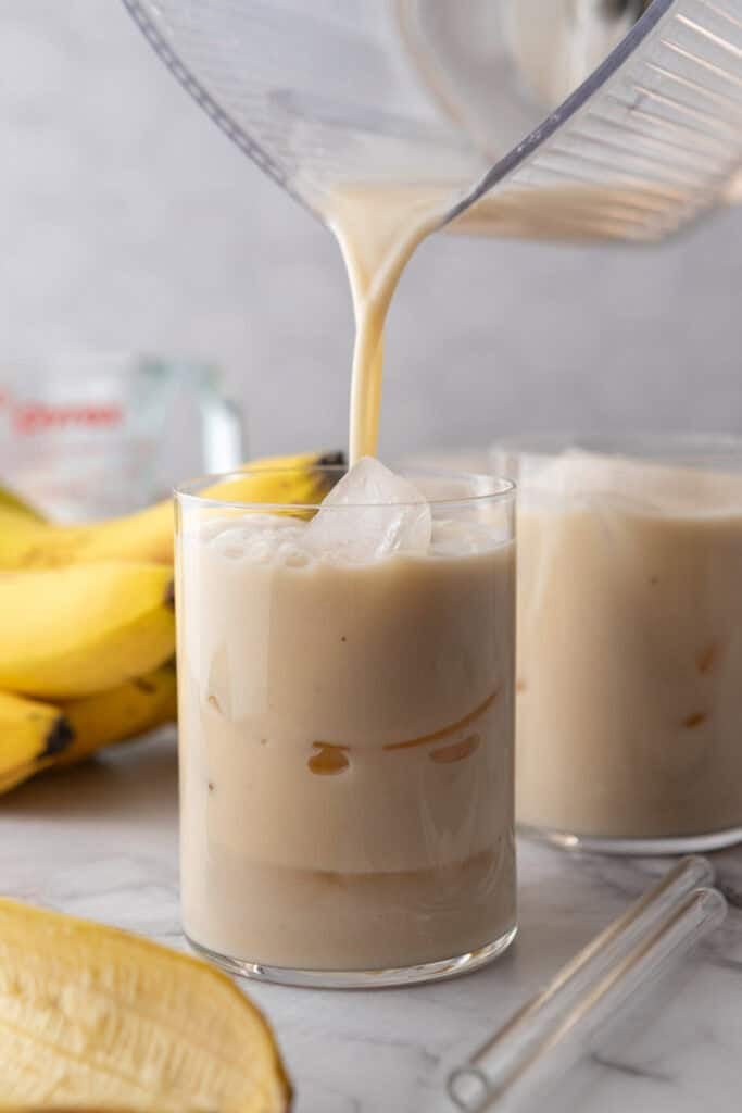 Korean Banana Milk Recipe being poured into a glass