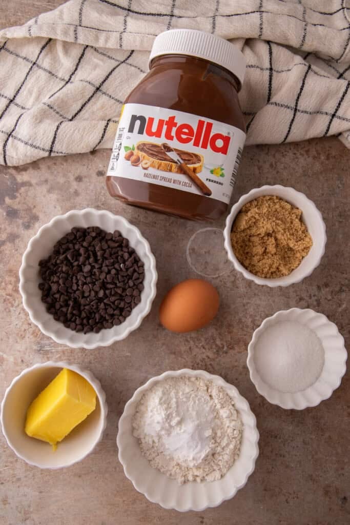Stack of split Nutella chocolate chip cookies showing molten Nutella filling