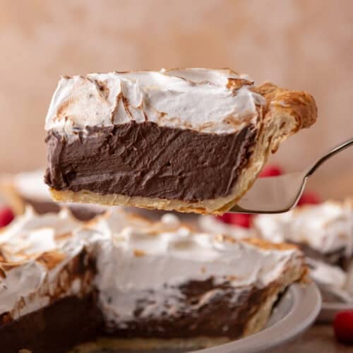 chocolate meringue pie slice on a serving spatula