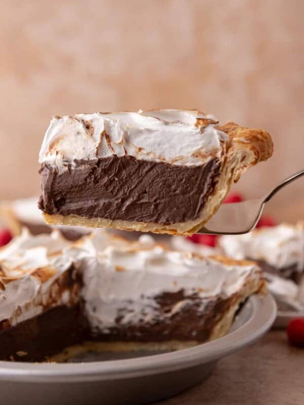 chocolate meringue pie slice on a serving spatula