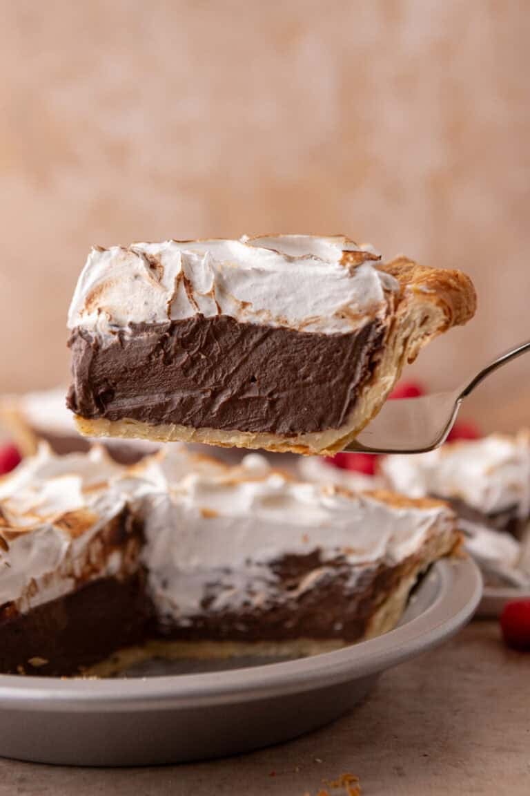 chocolate meringue pie slice on a serving spatula