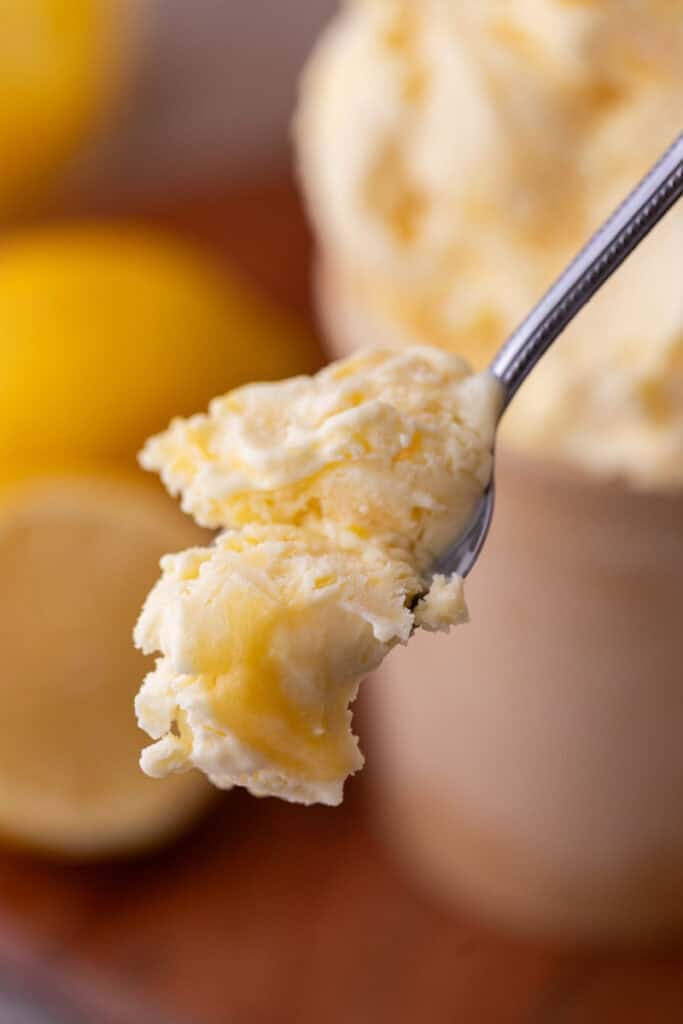 lemon custard ice cream recipe with lemon curd on a spoon