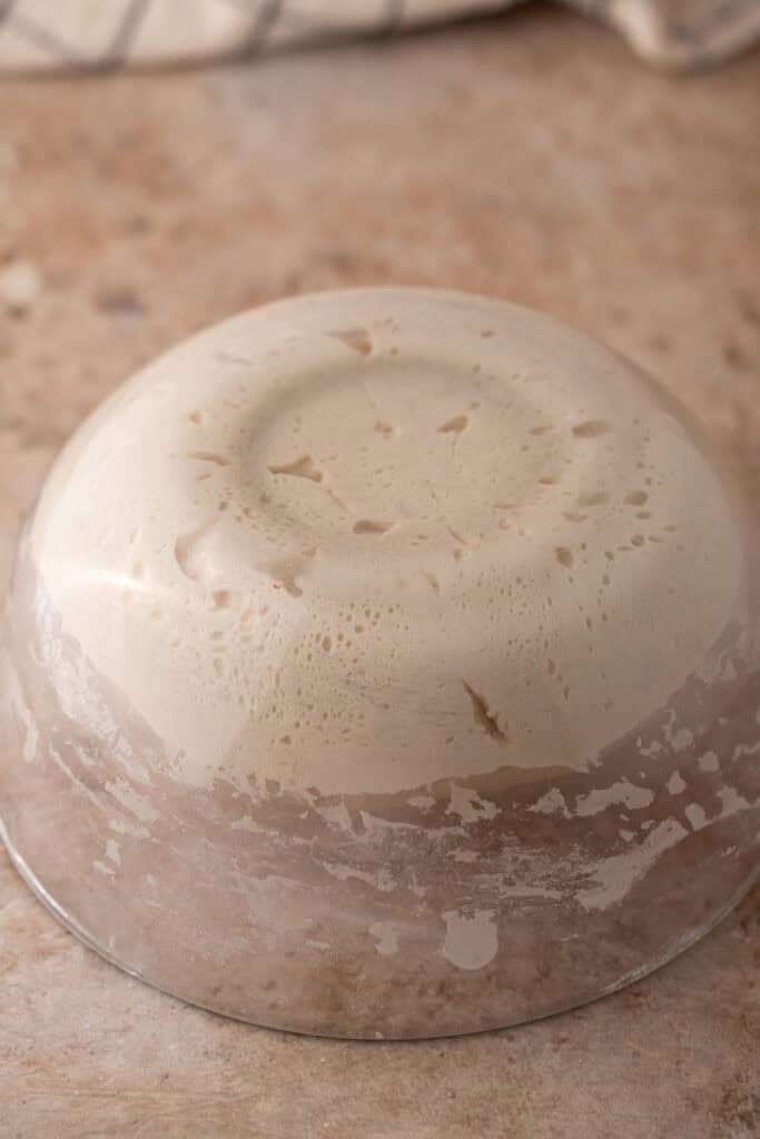 dough being flipped onto a table