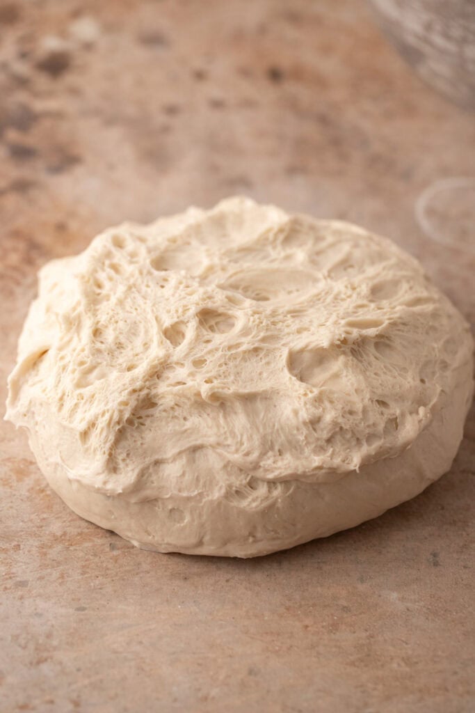 dough being flipped onto a table