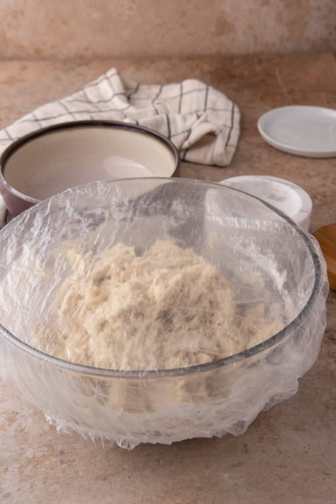 mixed ingredients in a bowl covered by plastic