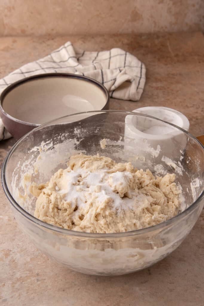 salt and dough being mixed in a bowl