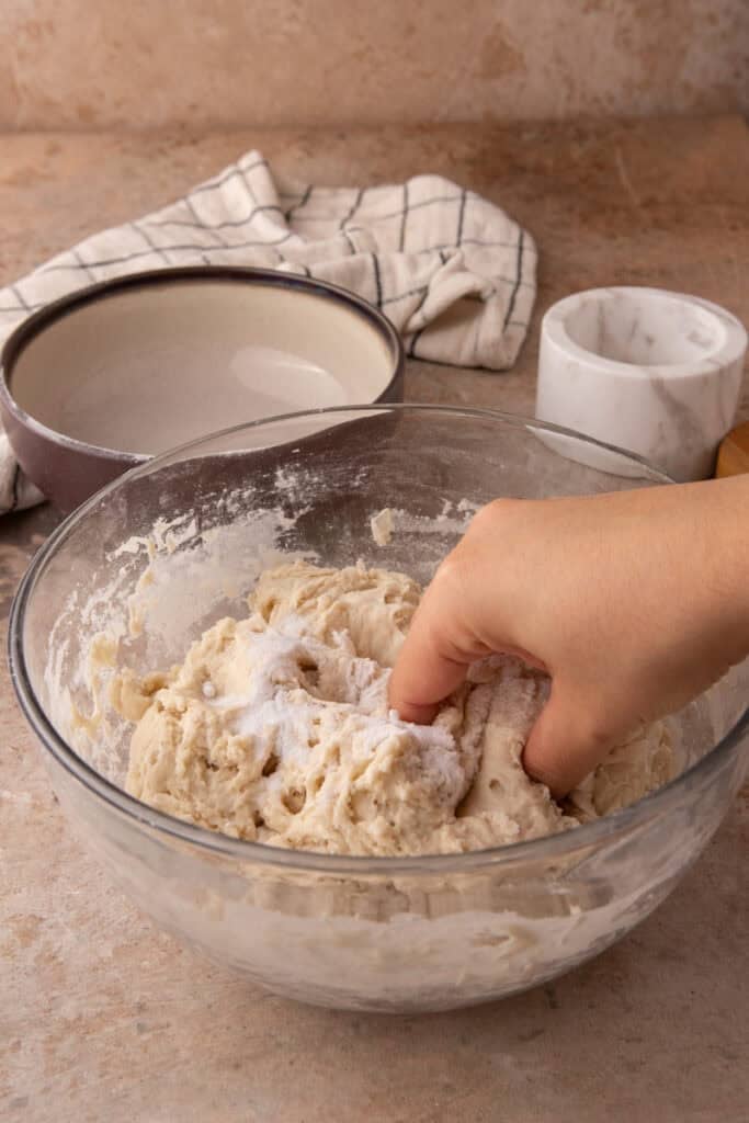 salt and dough being mixed in a bowl