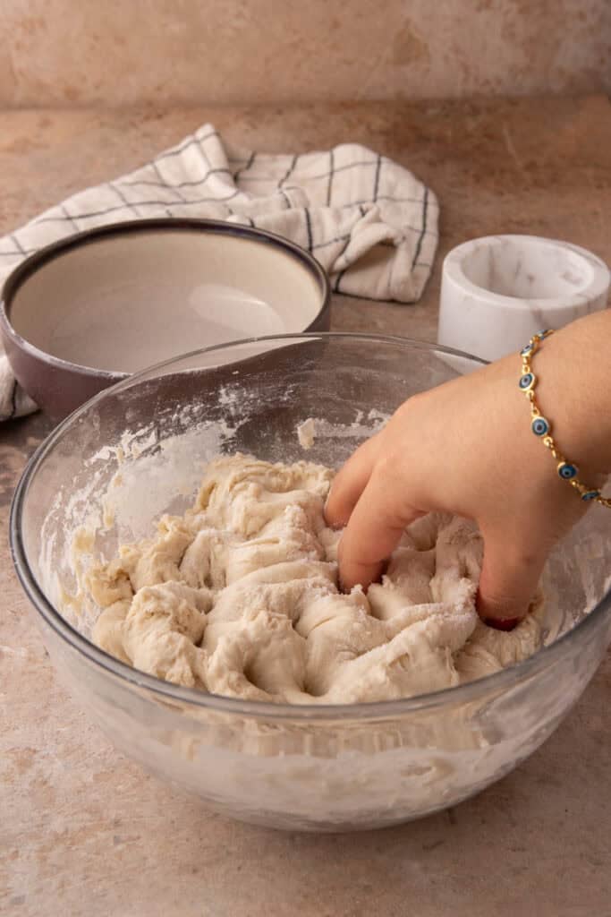 salt and dough being mixed in a bowl
