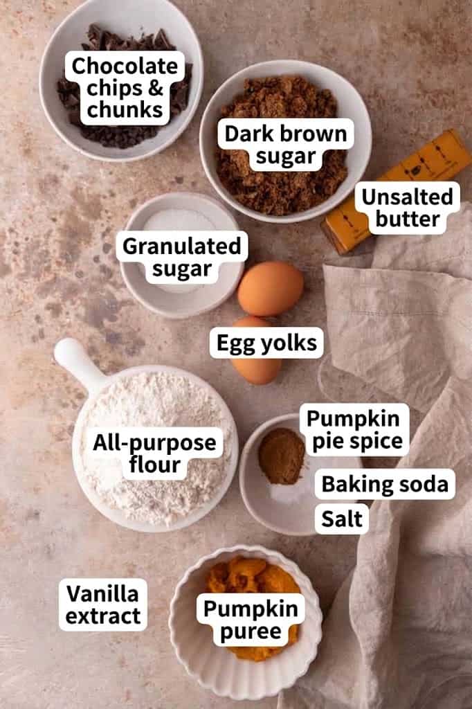 Labeled ingredients for pumpkin chocolate chip cookies including browned butter, pumpkin puree and egg yolks.