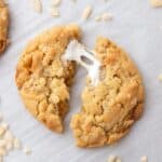 A Costco Marshmallow Crispy Cookie split in half with a melty marshmallow pulled and stretched between the two halves.