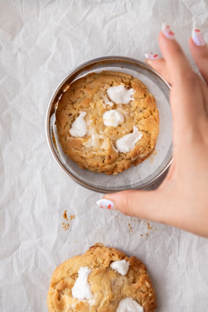 hand swirling cookie inside a cookie cutter