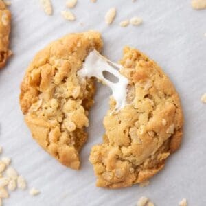 A Costco Marshmallow Crispy Cookie split in half with a melty marshmallow pulled and stretched between the two halves.