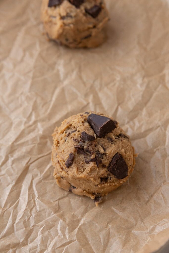 Cookie dough ball on parchment paper