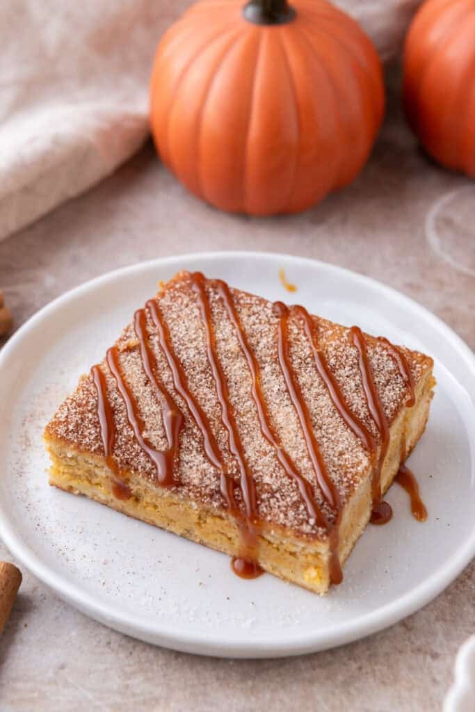 Churro pumpkin cheesecake bars on a plate