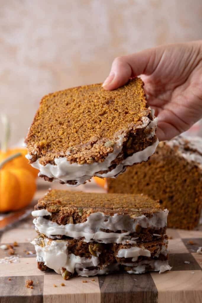 streusel pumpkin bread being picked up by a hand