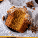 Copycat Panera Bread pumpkin muffin with a bite taken out, showing fluffy, moist crumb and sweet streusel topping
