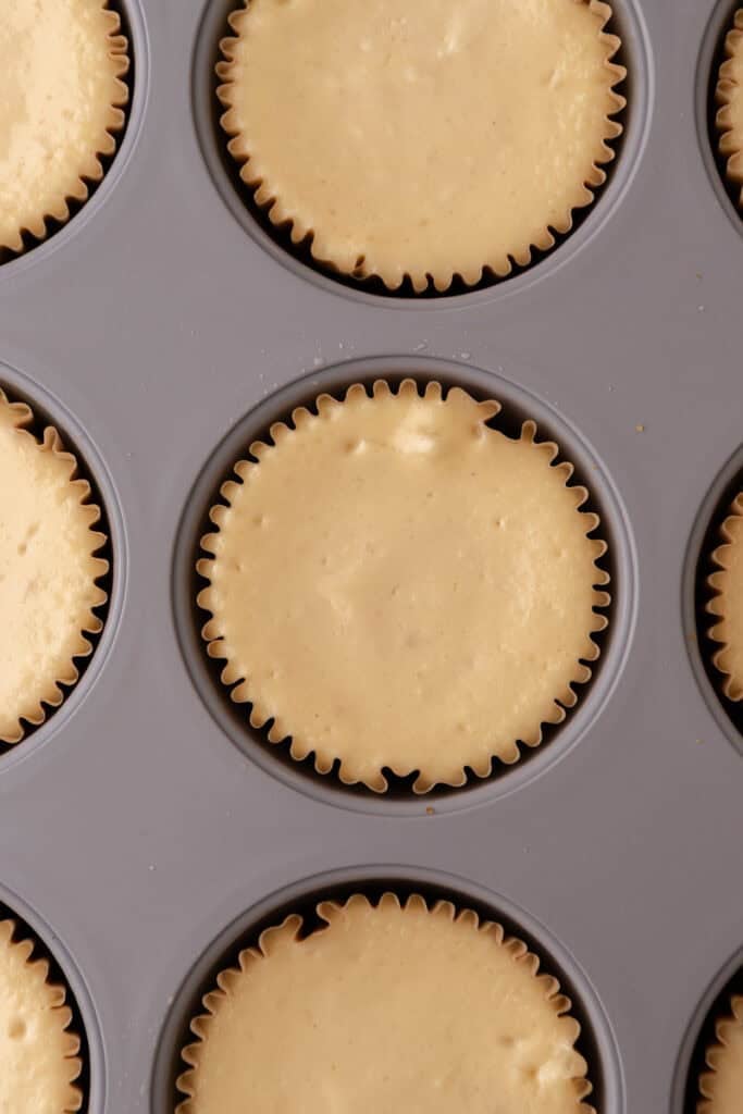 Mini Pecan Pie Cheesecakes in a muffin tin