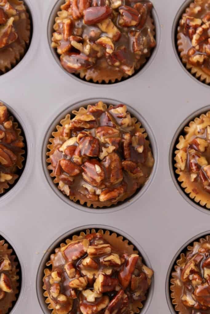 Mini Pecan Pie Cheesecakes in a muffin tin