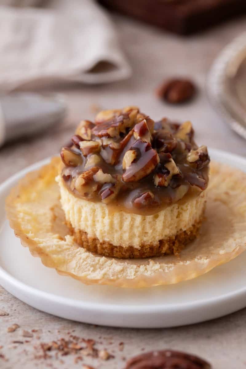 Mini Pecan Pie Cheesecakes on an opened muffin liner