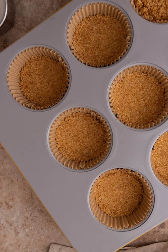 mixed crust ingredients in a muffin tin