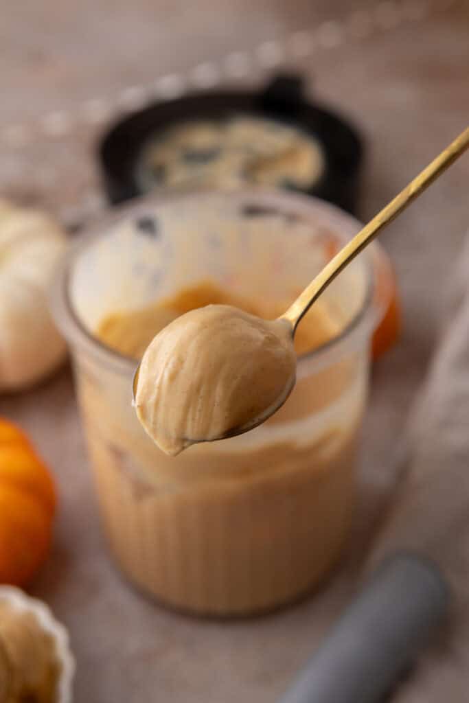 mixture base in the pint container after being blended and now being scooped by a spoon