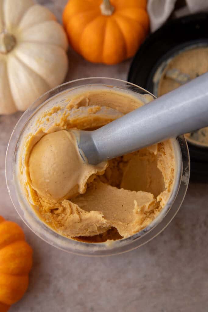 mixture base in the pint container after being blended and now being scooped by an ice cream scooper