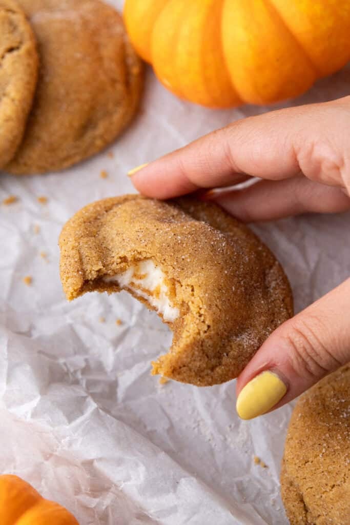 Pumpkin Cheesecake Cookie being picked up by a hand