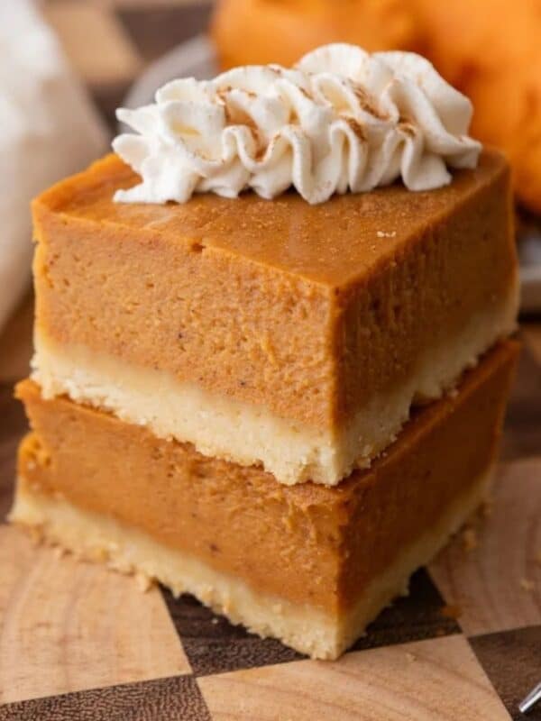 sweet potato pie bars recipe squares stacked on one on top of another.