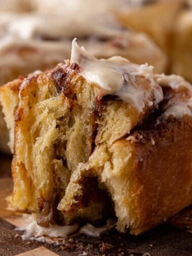 Soft brioche cinnamon roll with gooey cinnamon filling and cream cheese icing
