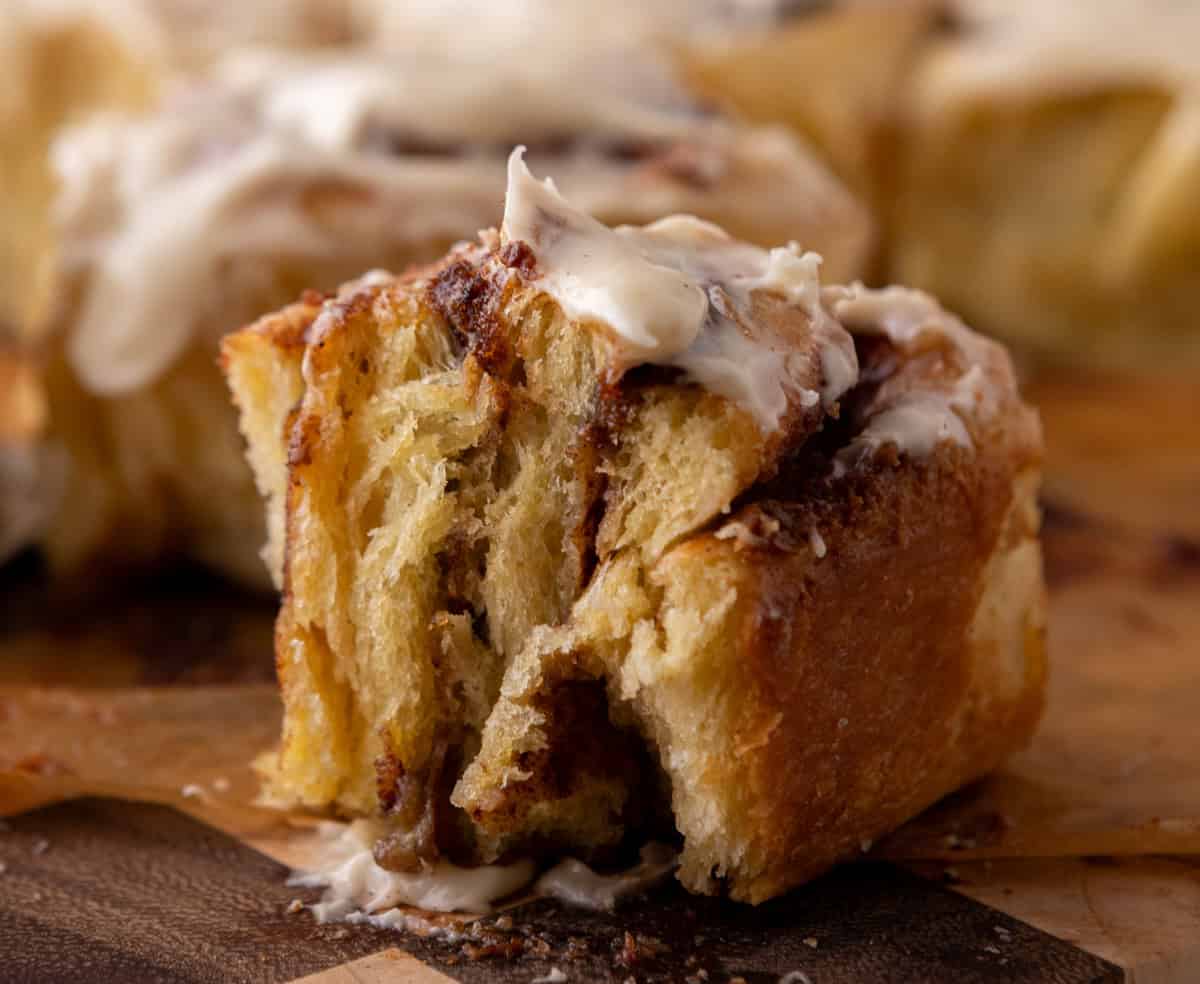 Soft brioche cinnamon roll with gooey cinnamon filling and cream cheese icing