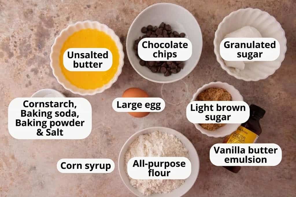 Overhead shot of ingredients for Crumbl Martha Stewart Chocolate Chip Cookies including melted butter, sugars, flour, egg, vanilla, and chocolate chips.