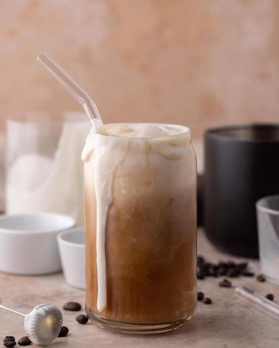 Thick vanilla sweet cream cold foam overflowing on top of a homemade Starbucks iced cold brew