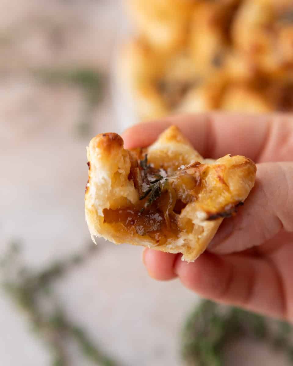 Bite taken out of a brie and fig jam puff pastry cup