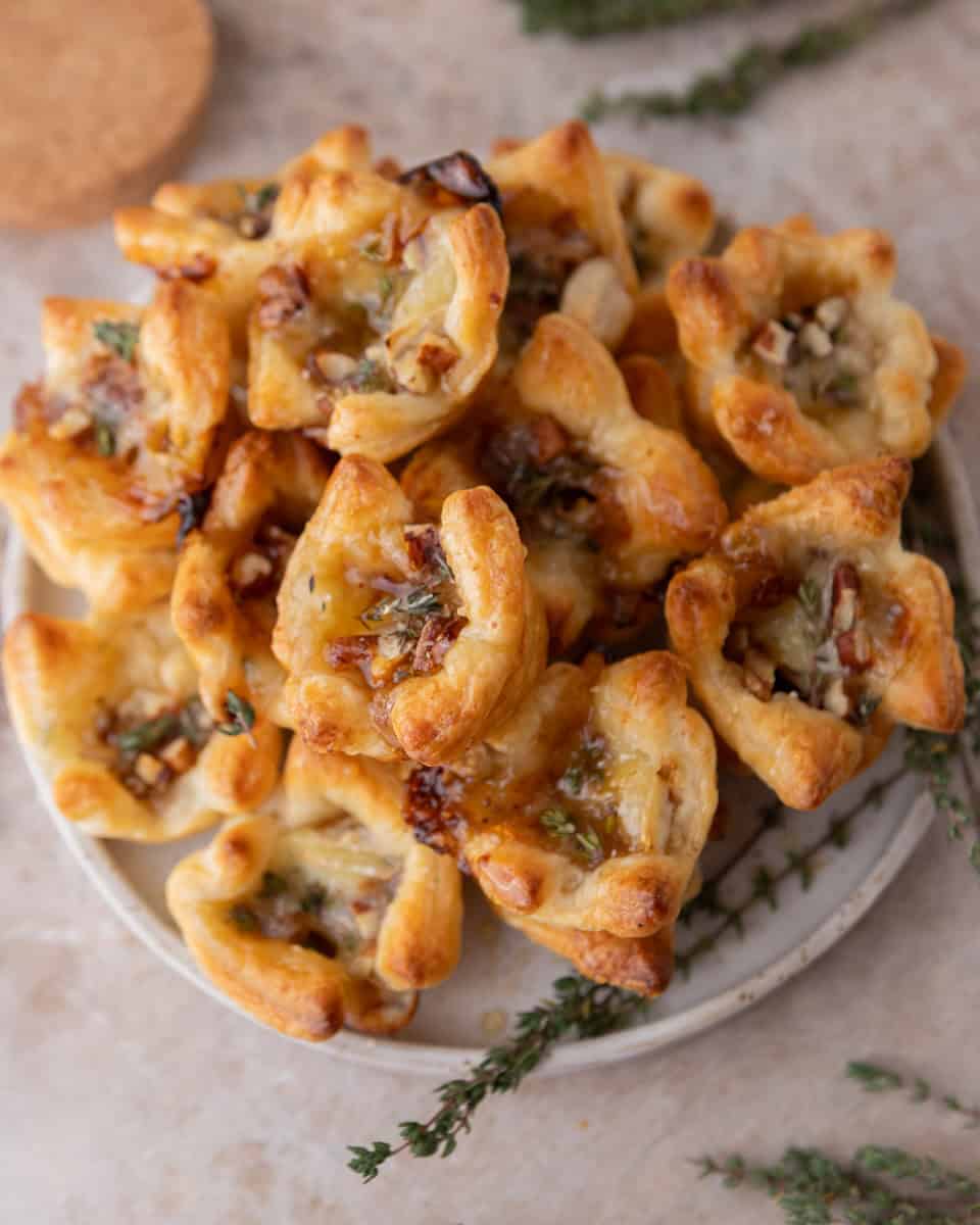 Brie and fig jam puff pastry cups baked until golden brown and topped with pecans