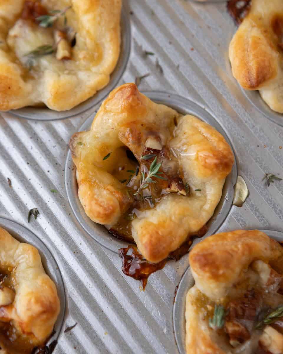 Brie and fig jam puff pastry cups baked in a muffin tin