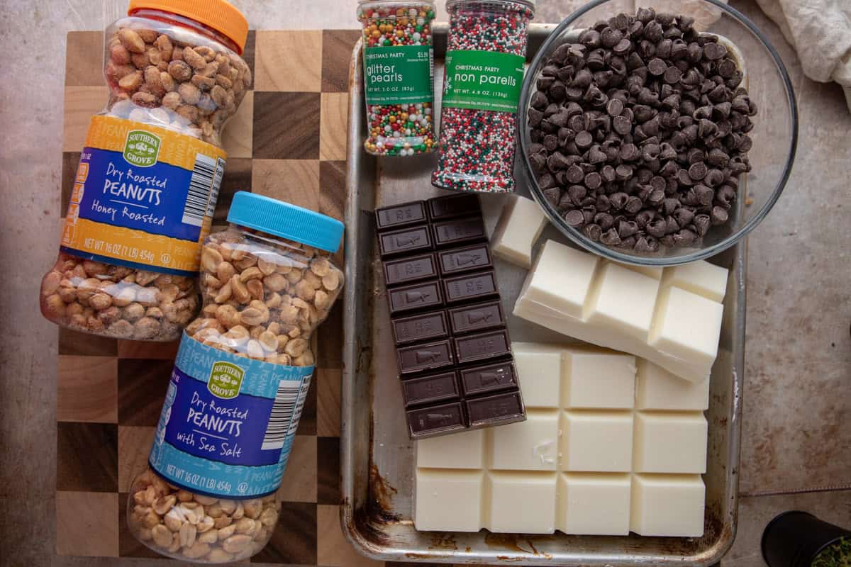 Ingredients including peanuts, almond bark, German chocolate, chocolate chips, and holiday sprinkles