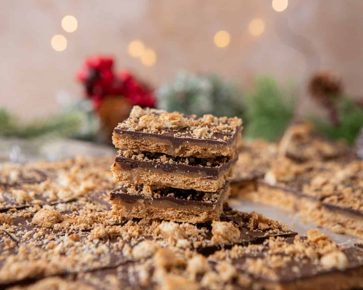 Graham cracker Christmas crack stacked in layers with chocolate and toffee
