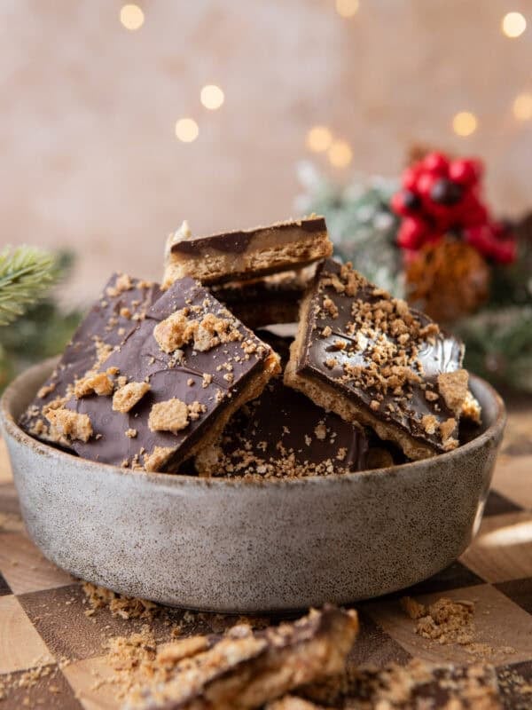Bowl of graham cracker Christmas crack with chocolate and toffee layers