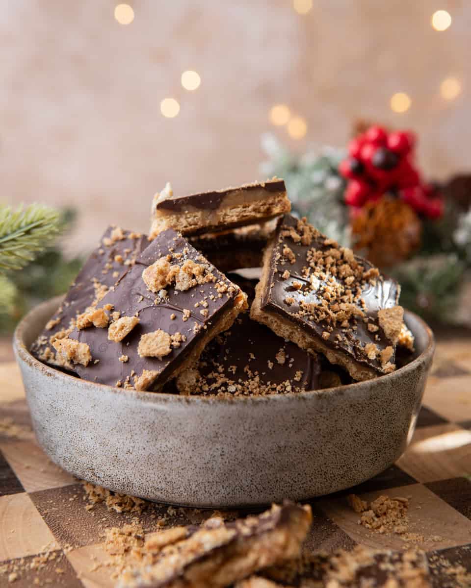 Bowl of graham cracker Christmas crack with chocolate and toffee layers
