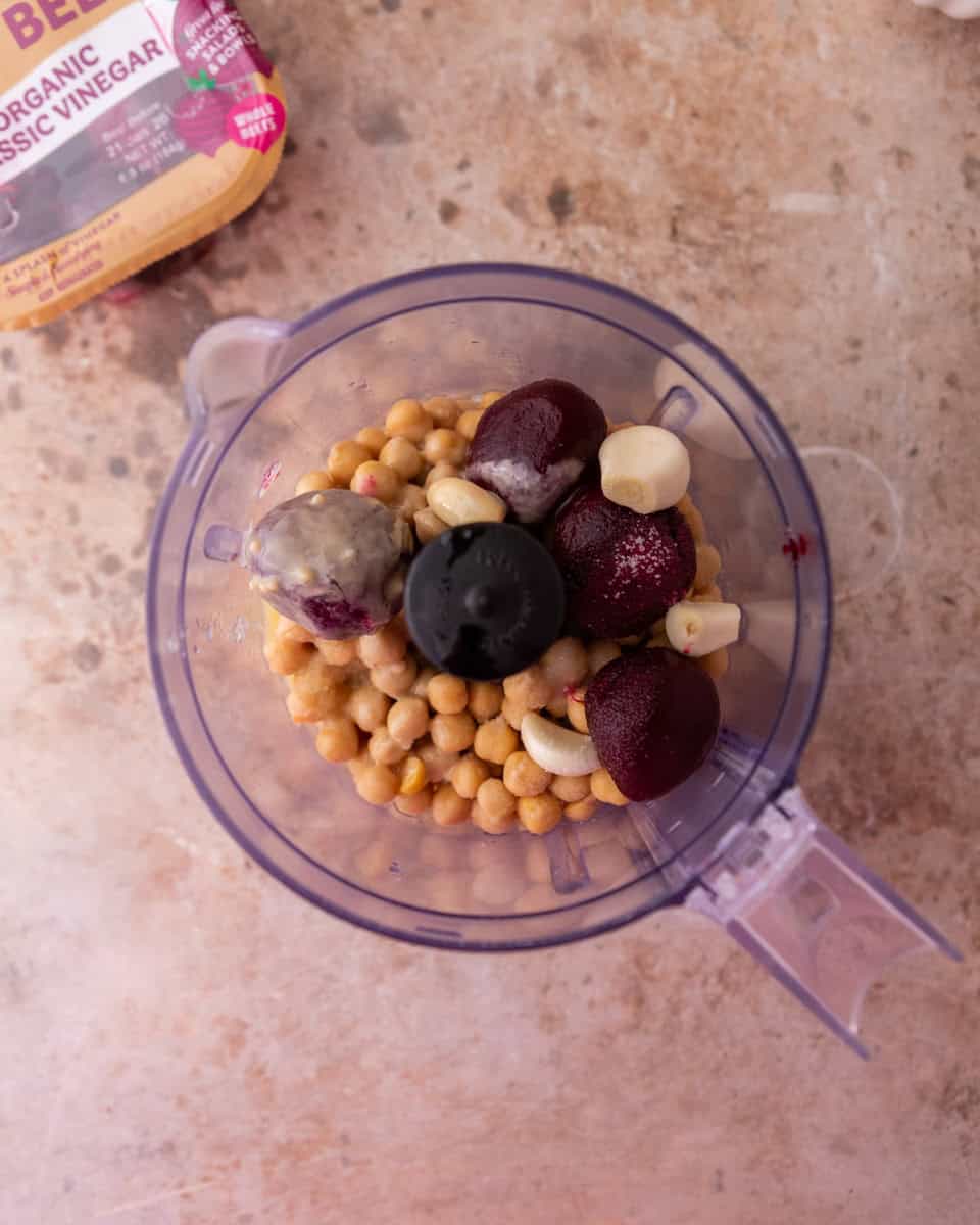 Food processor blending chickpeas and beets