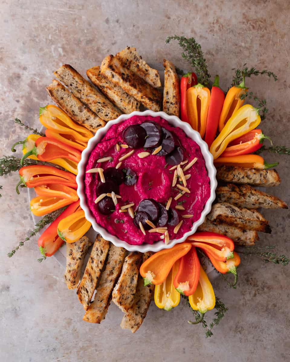 Colorful appetizer platter with dip and fresh vegetables