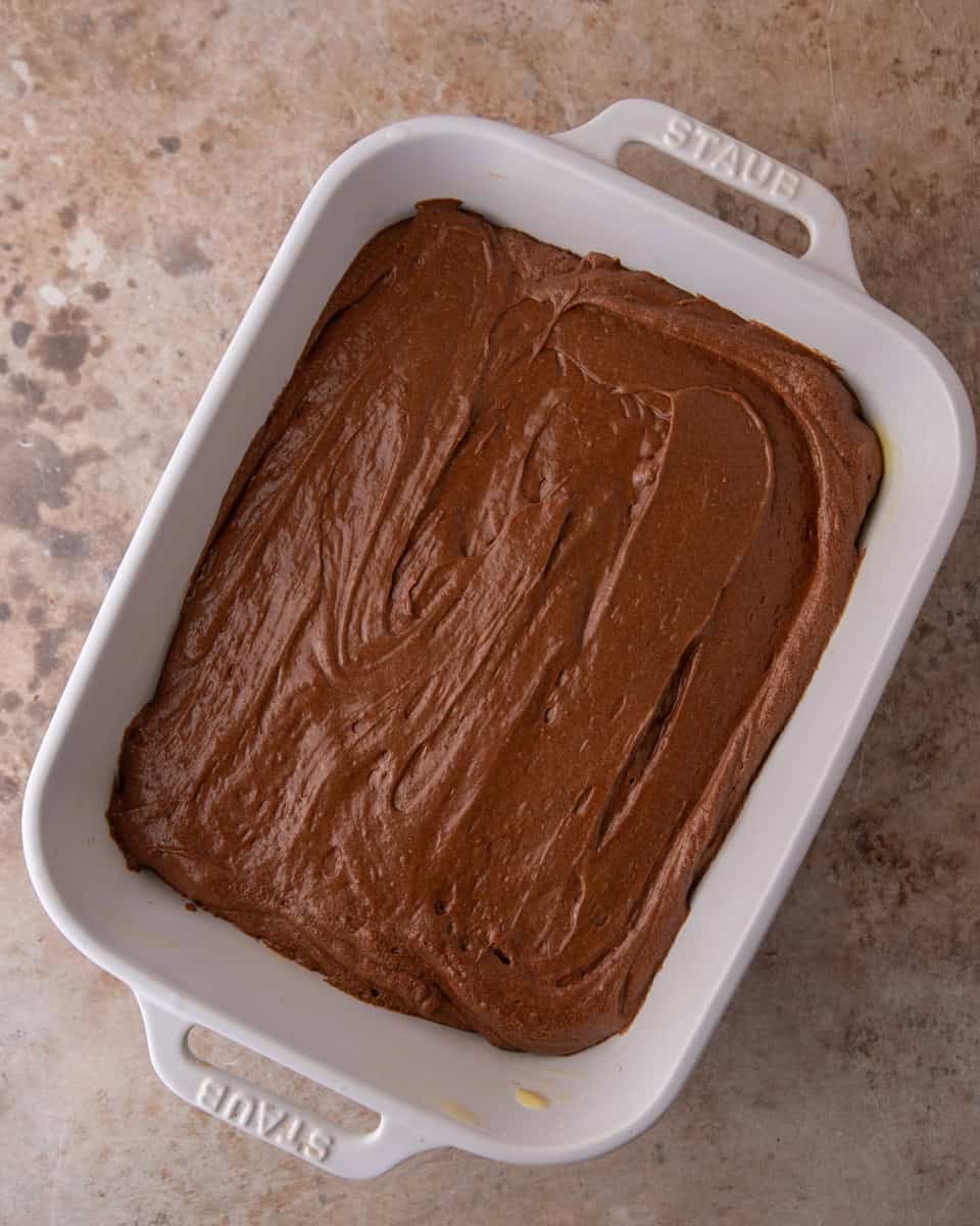 Brownie pudding batter spread evenly in a baking dish before baking