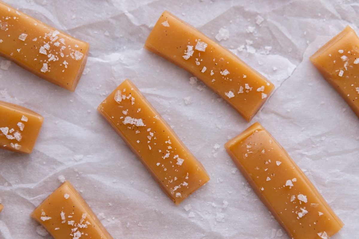 Close-up of soft homemade caramels sprinkled with flaky sea salt
