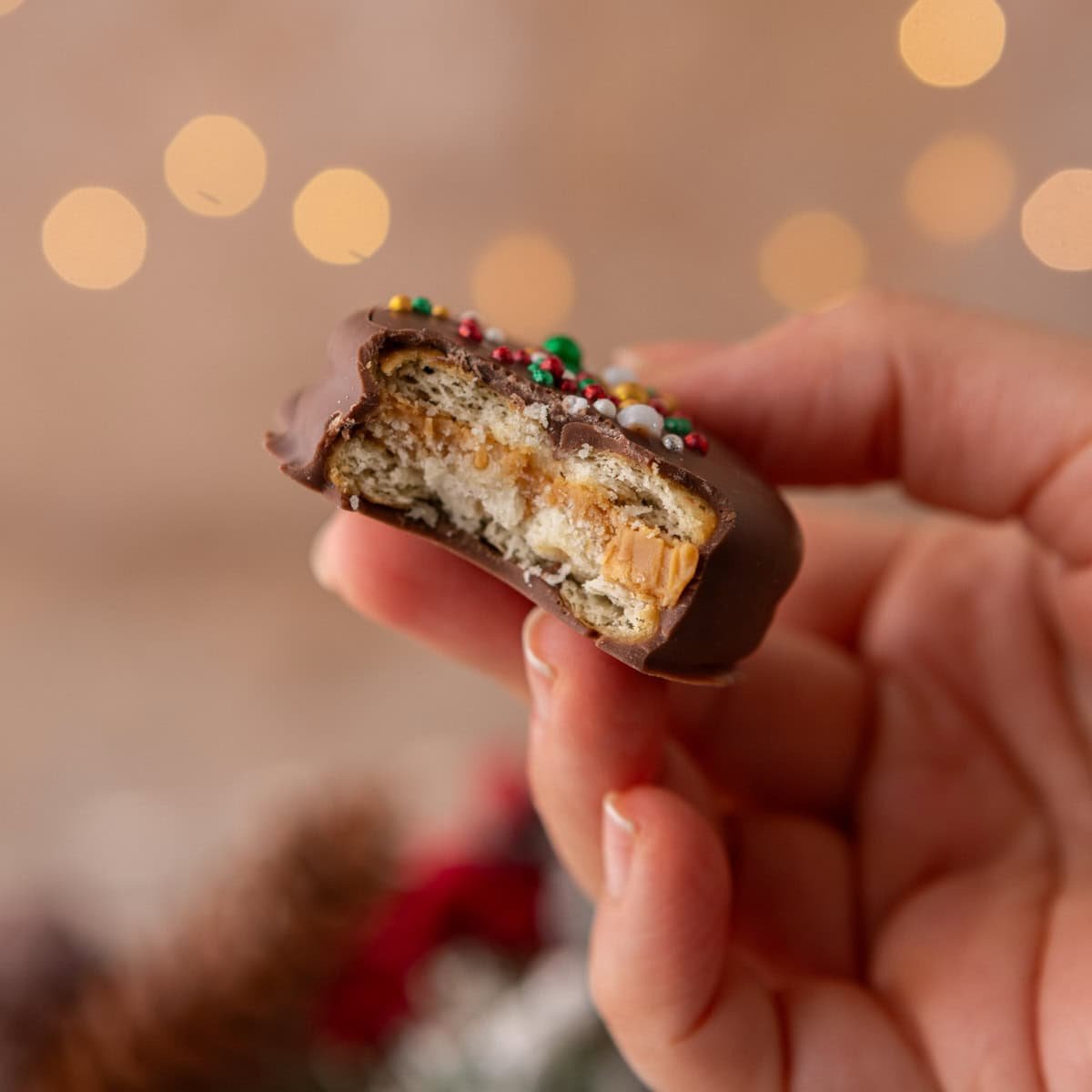 Ritz peanut butter cookies with a bite taken out showing creamy peanut butter filling